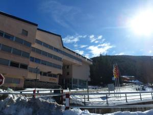 a building with a pile of snow in front of it at Apartment La Molina in La Molina