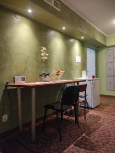 a table in a room with two chairs and a kitchen at Hostel Promyk in Iwonicz-Zdrój