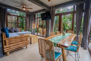a living room with a dining table and a couch at Buko Beach Resort in El Nido
