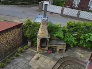 an outdoor brick oven in front of a building at Hostel Promyk in Iwonicz-Zdrój +3 photos