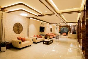 a large living room with couches and a table at Raphilhin The Business Hotel in Perintalmanna