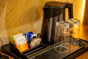 a coffee maker sitting on top of a counter at Raphilhin The Business Hotel in Perintalmanna