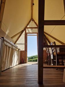 an inside view of a tent with a large window at Tente Lodge Logement Insolite 4pers Campagne Normande Orne in Ménil-Hubert-sur-Orne +36 photos