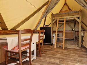 a dining room in a tent with a table and chairs at Tente Lodge Logement Insolite 4pers Campagne Normande Orne in Ménil-Hubert-sur-Orne