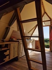 a ladder leading to a room in a tent at Tente Lodge Logement Insolite 4pers Campagne Normande Orne in Ménil-Hubert-sur-Orne