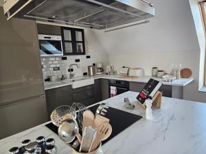 a kitchen with a white counter top with a counter top at Cap à l'ouest in Saint-Benoît-des-Ondes +20 photos
