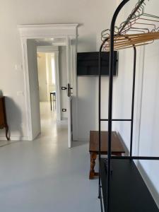 a room with a bed and a hallway with a table at Casa Margo in Campobasso
