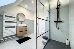 a bathroom with a glass shower and a sink at Spacious house 300m from the beach in Hermanville-sur-Mer +15 photos