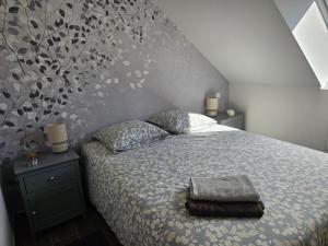 a bedroom with a bed with two pillows on it at Cap à l'ouest in Saint-Benoît-des-Ondes