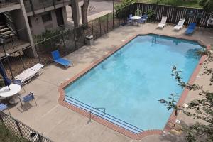 an overhead view of a large swimming pool with chairs and tables at Ramada by Wyndham Westminster Denver in Westminster