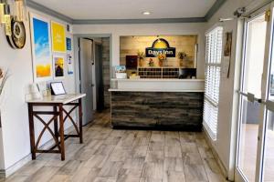 a restaurant lobby with a counter and wooden floors at Days Inn by Wyndham Donalsonville in Donalsonville