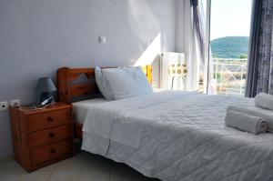 a bedroom with a large bed and a window at Valtaki Holiday Home in Selinitsa