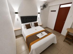a bedroom with a large bed with a towel on it at Hotel World Peru in Lima