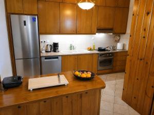 a kitchen with a bowl of fruit on a counter at Villa Maria Christina with Private Pool in Crete in Skoúrvoula +16 photos