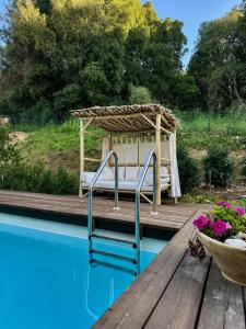 a bed on a wooden deck next to a pool at זוג ידיים - סוויטה עם בריכה פרטית, סאונה וג'קוזי in H̱osen