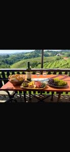 a table with plates of food and a bottle of wine at Haloze Chill in Podlehnik