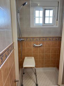 a shower with a chair in a bathroom at Las Delicias de Estepona in Estepona +31 photos