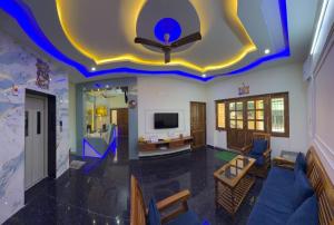 a living room with a blue and yellow ceiling at Gravity Groups Core - Sakthi residency in Puducherry Airpoert