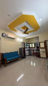 a living room with a blue couch and a ceiling at Gravity Groups Core - Sakthi residency in Puducherry Airpoert +10 photos