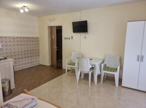 a room with a table and chairs and a television at Apartments Blink in Orebić +24 photos
