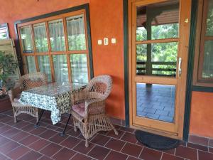 a patio with a table and chairs on a porch at Agyagos Vendégház in Eger