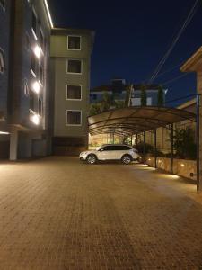 a car parked in a parking lot at night at Mzuri Homes in Kampala
