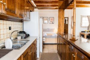 a kitchen with a sink and a bed in a room at Stathohouse - Peaceful Balcony Retreat in Filiatra in Filiatra