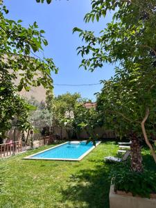 a swimming pool in the yard of a house at Les Chambres Salonaises in Salon-de-Provence