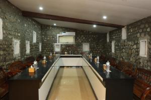 a conference room with a long table and chairs at Thimura Resort in Bharatpur