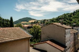 a view of a town with hills and buildings at Appartement central - L'est in Tarare