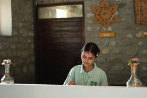 a young girl standing in front of a counter at Thimura Resort in Bharatpur +92 photos