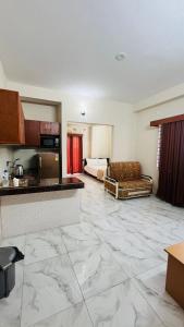 a hotel room with a kitchen and a living room at Best Eastern Suite in Dhaka