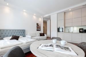 a living room with a table and a couch at Rynek 45 Apartament in Wrocław