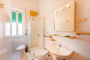 a bathroom with a sink and a toilet and a mirror at Hotel Riviera in Procida +41 photos