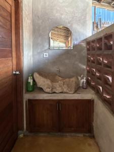 a bathroom with a sink and a wooden cabinet at Homestay IDR Bali in Jimbaran