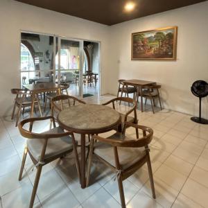 a group of tables and chairs in a room at Homestay IDR Bali in Jimbaran