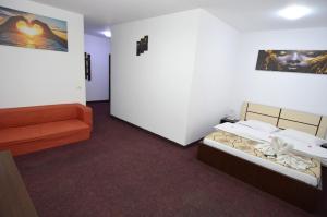 a room with two beds and an orange couch at Razvan Holiday in Costinesti +171 photos