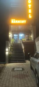 a entrance to a store with stairs and a car parked in front at Hotel Harmony in Kharar