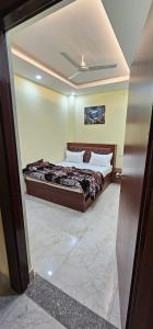 a bedroom with a bed and a ceiling at Hotel Sunny in Varanasi