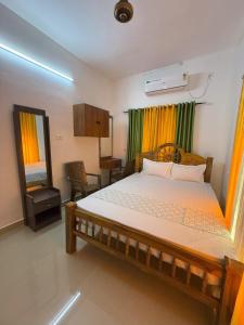 a bedroom with a bed and a mirror in it at Soul Shore, Varkala in Varkala