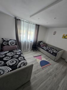 a bedroom with two beds and a couch in it at Ferienwohnung Monteurzimmer Mariens1 in Eppelborn