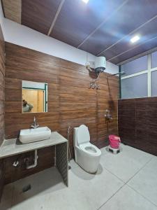 a bathroom with a toilet and a sink at Brahma Heritage Resort in Pushkar