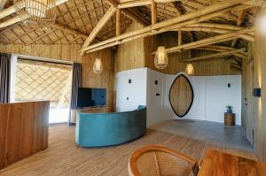 a large room with a wooden ceiling and a table at Buenavista Lux Villas in Kuta Lombok