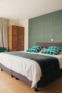 a bedroom with a large bed in a room at B&B Maaltebrug in Ghent