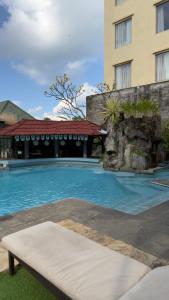 a large swimming pool in front of a building at Seminyak Paradiso Hotel in Seminyak