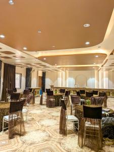 a banquet hall with chairs and a bar at Hotel Aashiyana in Shahdol