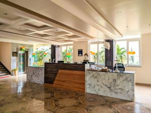 a lobby with a bar with marble counter tops at Hotel Aashiyana in Shahdol