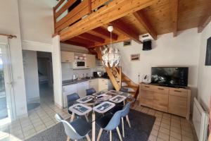 a kitchen and dining room with a table and chairs at Cozy apartment with lake view in Gérardmer
