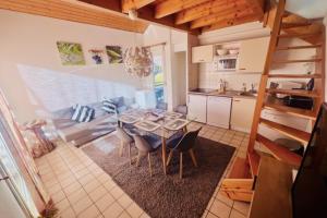 a kitchen and dining room with a table and chairs at Cozy apartment with lake view in Gérardmer +69 photos