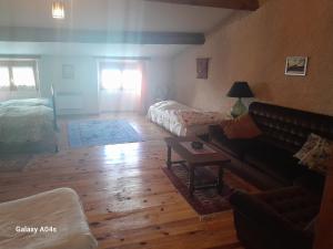 a living room with a couch and a table at Chambres d'hôtes de charme "La Tour Richelieu" in Martres-de-Veyre
